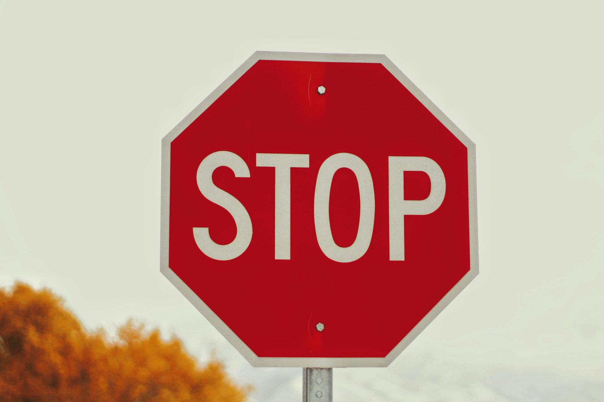 https://unsplash.com/photos/a-red-stop-sign-sitting-on-top-of-a-metal-pole-6Jls3UzPNik